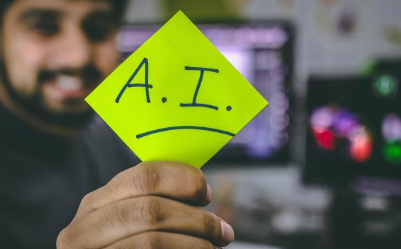 man holding yellow page with letters A I