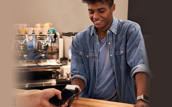 young man paying for items 