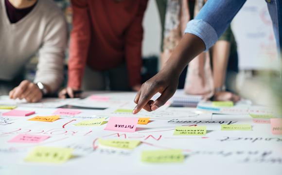 hands pointing to sticky notes