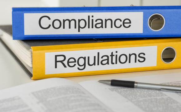 Folders with the label Compliance and Regulations stock photo