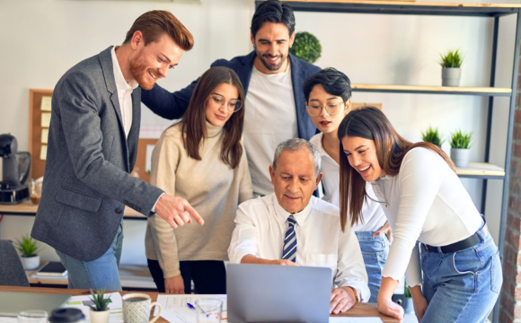 People gathered around a computer